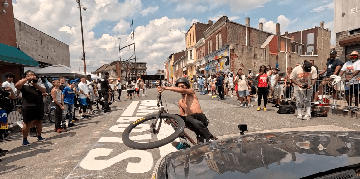 A Crash Boys rider performing for a crowd on a city street